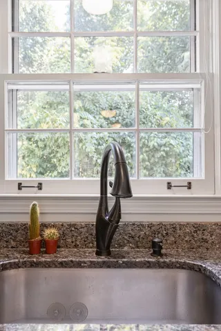 a kitchen with a refrigerator and a sink