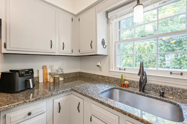 a kitchen with stainless steel appliances granite countertop a stove and a microwave