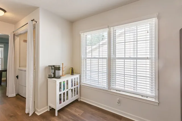 a view of a dining room with a table and chairs