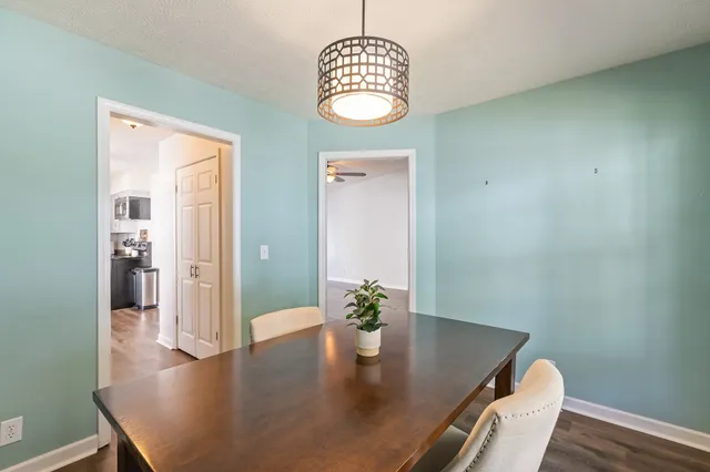 a view of a dining room with furniture wooden floor and chandelier