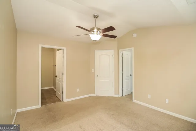 a view of a room with a ceiling fan and a chandelier fan