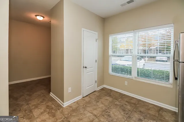a view of a big room with windows and entryway