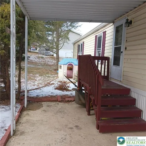 a view of a porch with furniture and front door