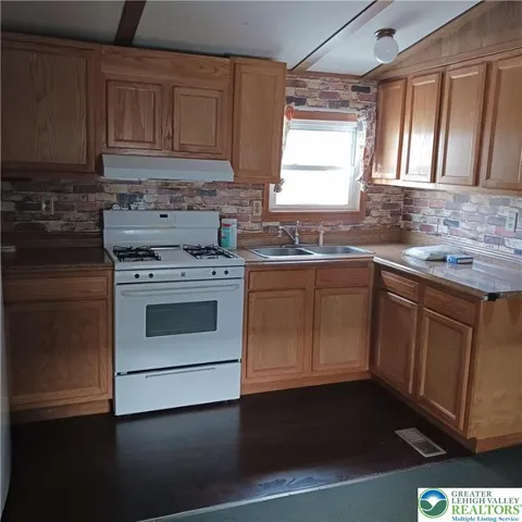 a kitchen with a sink stove and cabinets