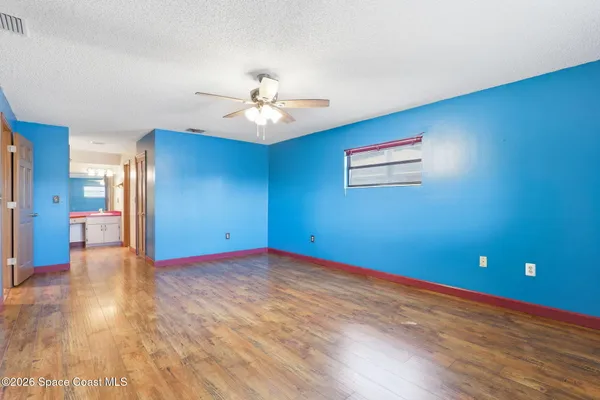 a view of empty room with wooden floor