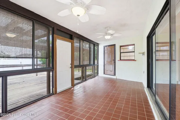 a view of an empty room with window and cabinet
