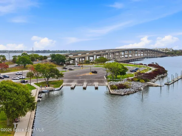 an aerial view of a house with swimming pool and lake view