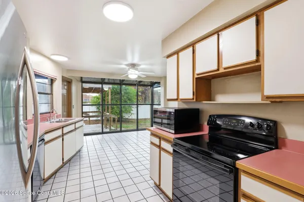 a kitchen with a stove a sink and a cabinets