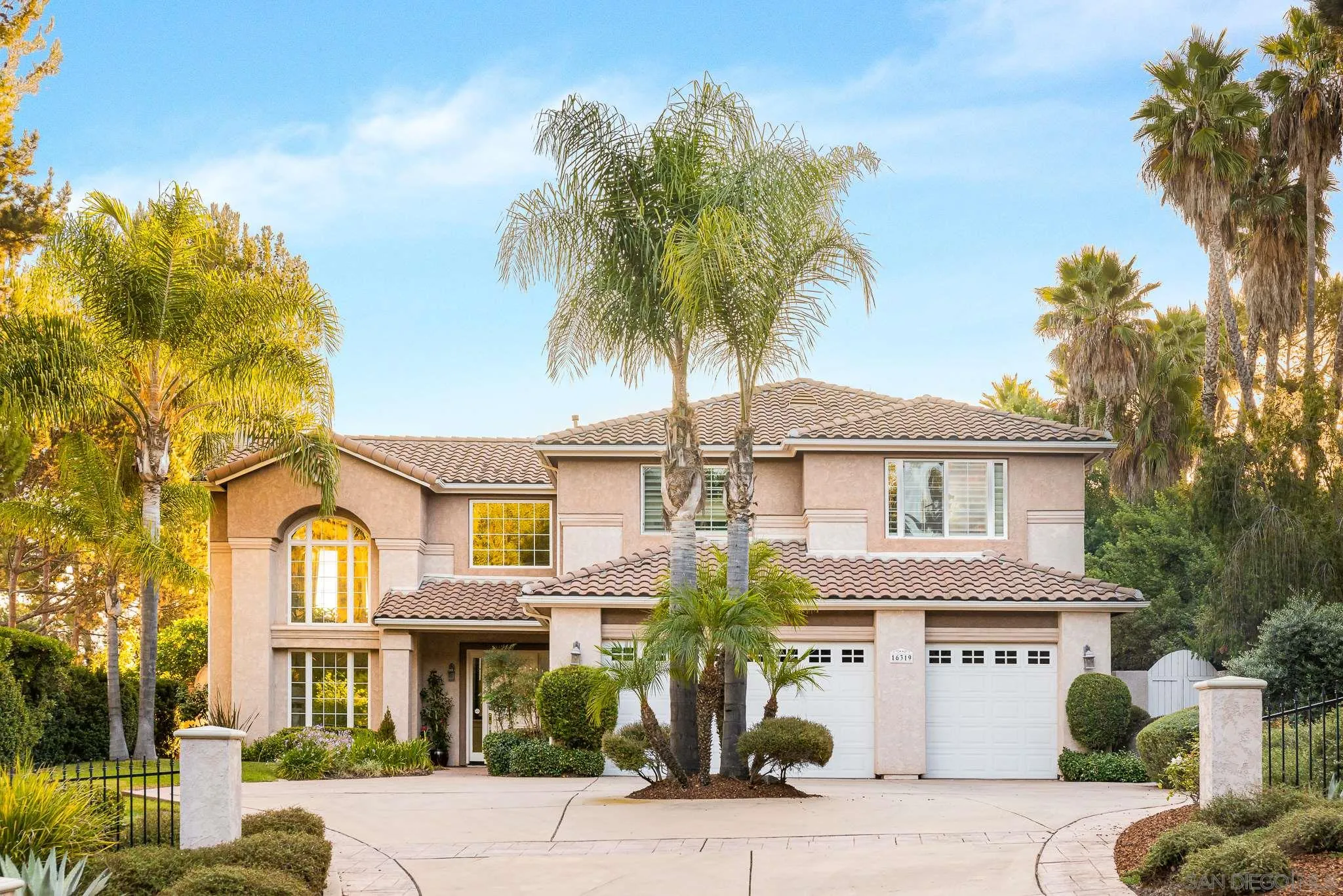 16319 Martincoit Road Poway, CA 92064 - Photo 1 of 29 a front view of a residential apartment building with a yard