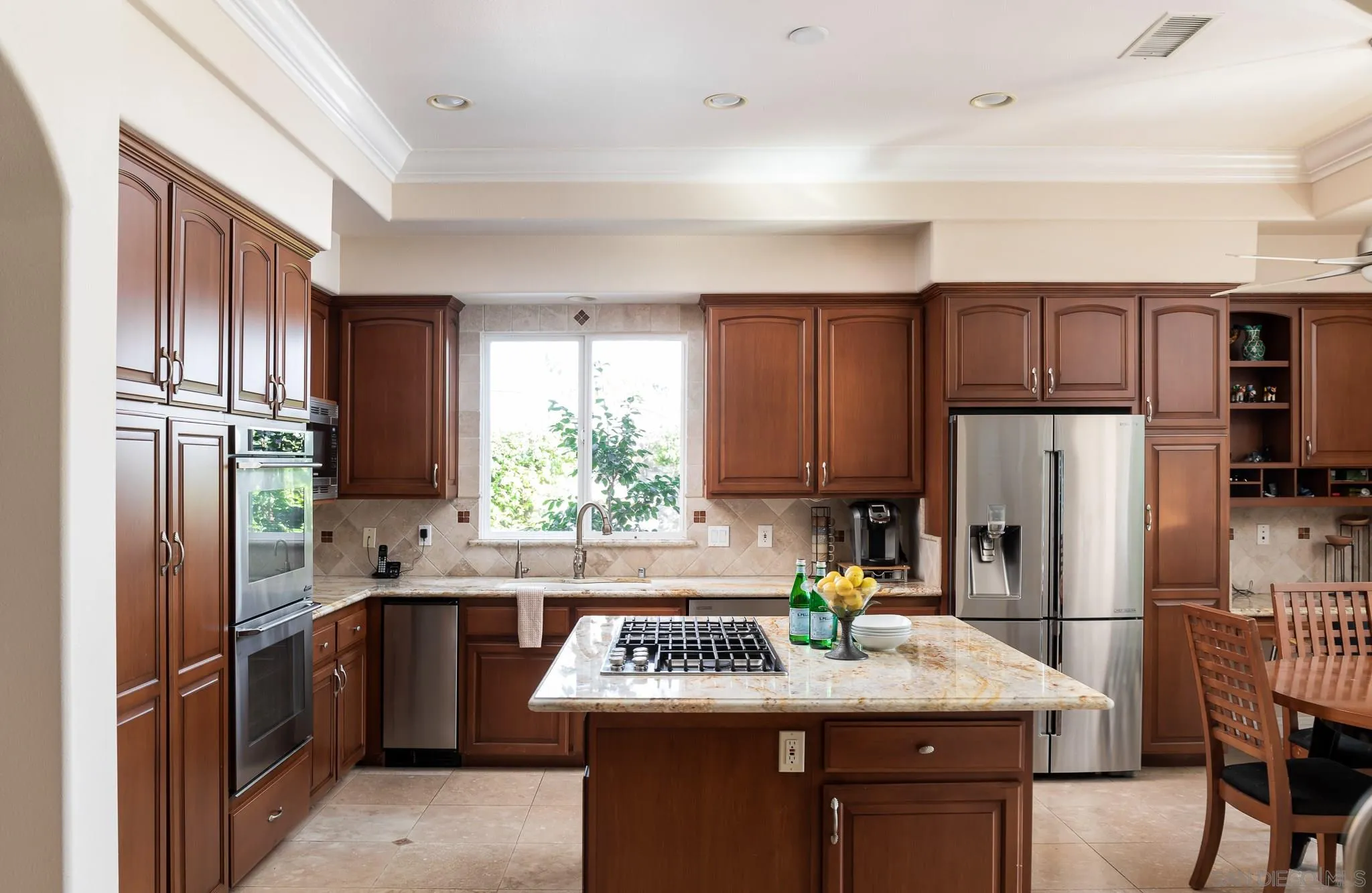 16319 Martincoit Road Poway, CA 92064 - Photo 8 of 29 a kitchen with kitchen island granite countertop a refrigerator stove microwave and sink