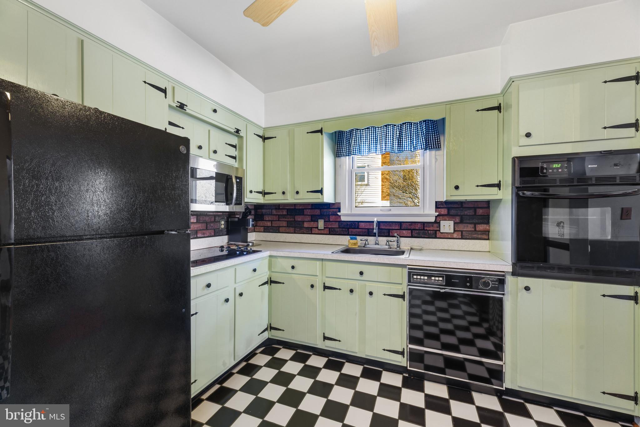 2019 Valley Road Annapolis, MD 21401 - Photo 11 of 42 a kitchen with a sink a refrigerator and cabinets