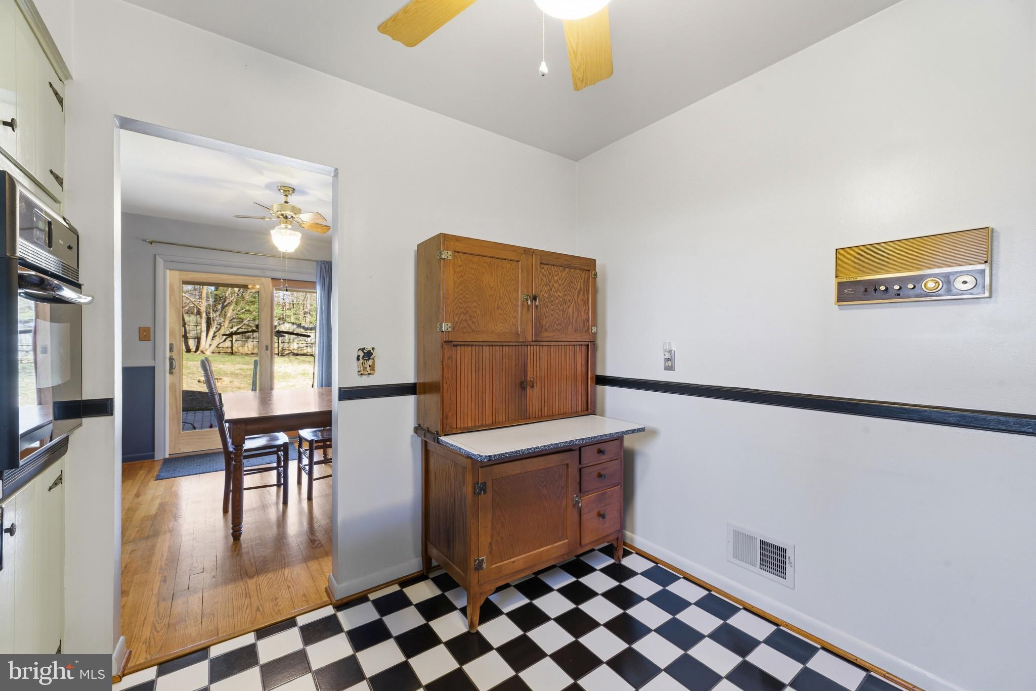 2019 Valley Road Annapolis, MD 21401 - Photo 12 of 42 a kitchen with granite countertop a refrigerator a stove a dining table and chairs with wooden floor