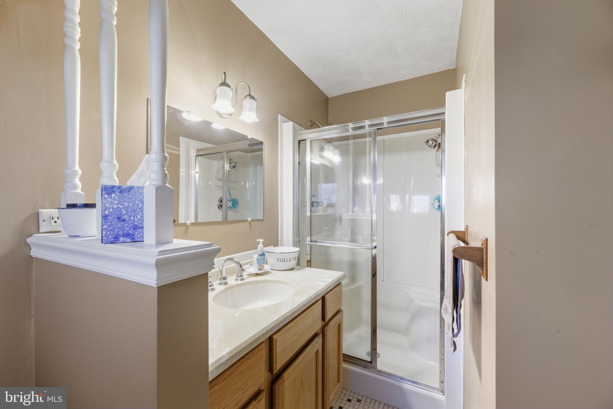 2019 Valley Road Annapolis, MD 21401 - Photo 18 of 42 a bathroom with a shower sink vanity and mirror