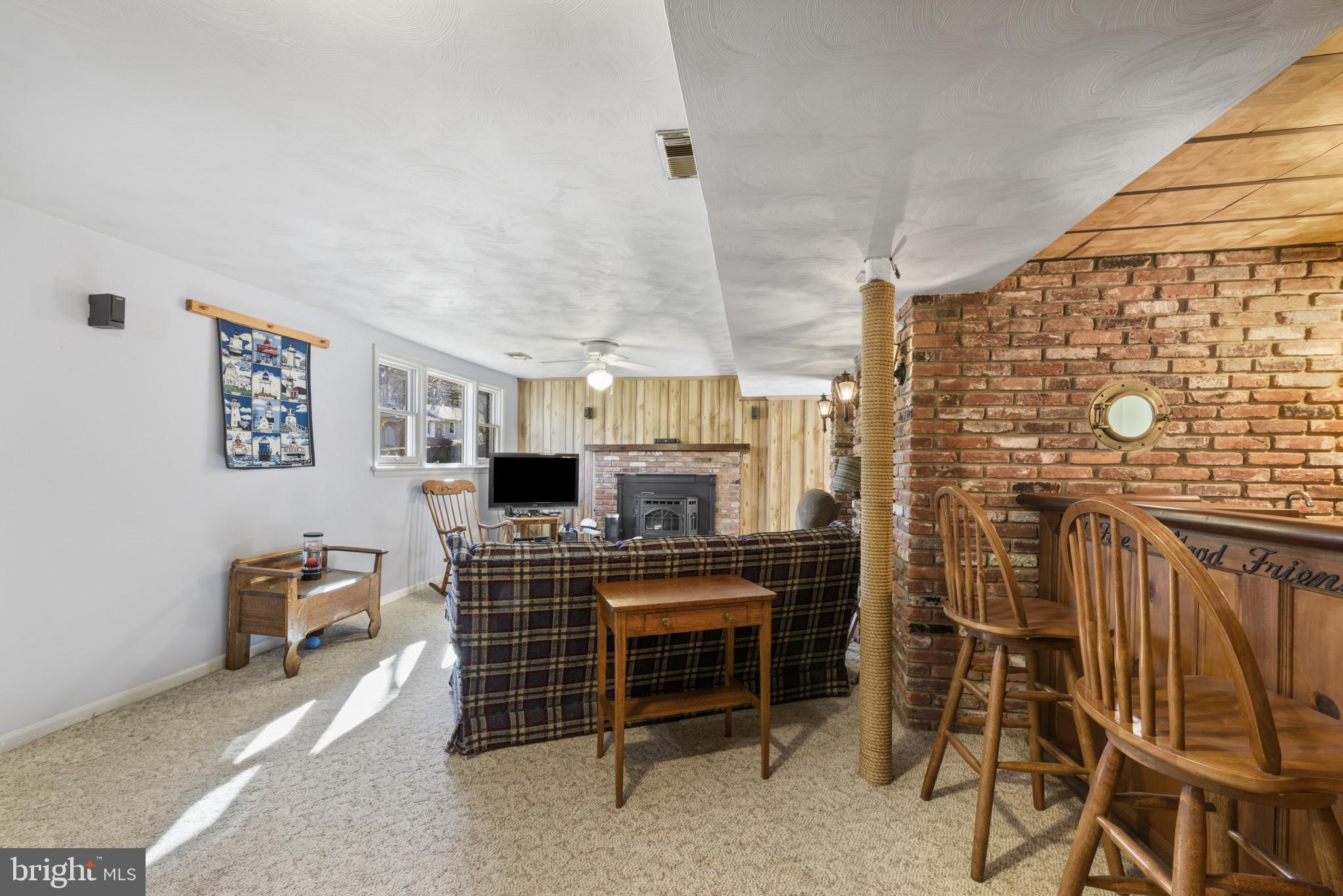 2019 Valley Road Annapolis, MD 21401 - Photo 25 of 42 a living room with furniture a flat screen tv and a fireplace