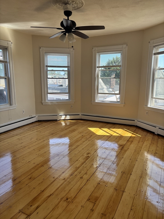a view of a room with wooden floor and windows