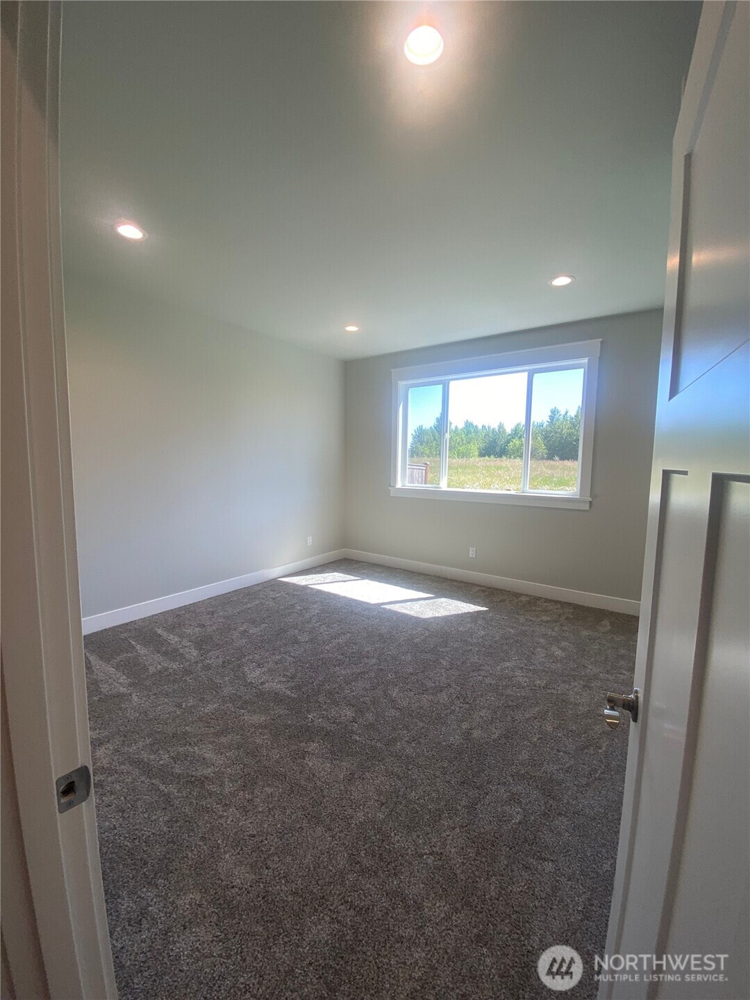 5953 (lot 64) Ranch Loop Ferndale, WA 98248 - Photo 14 of 38 an empty room with windows and refrigerator