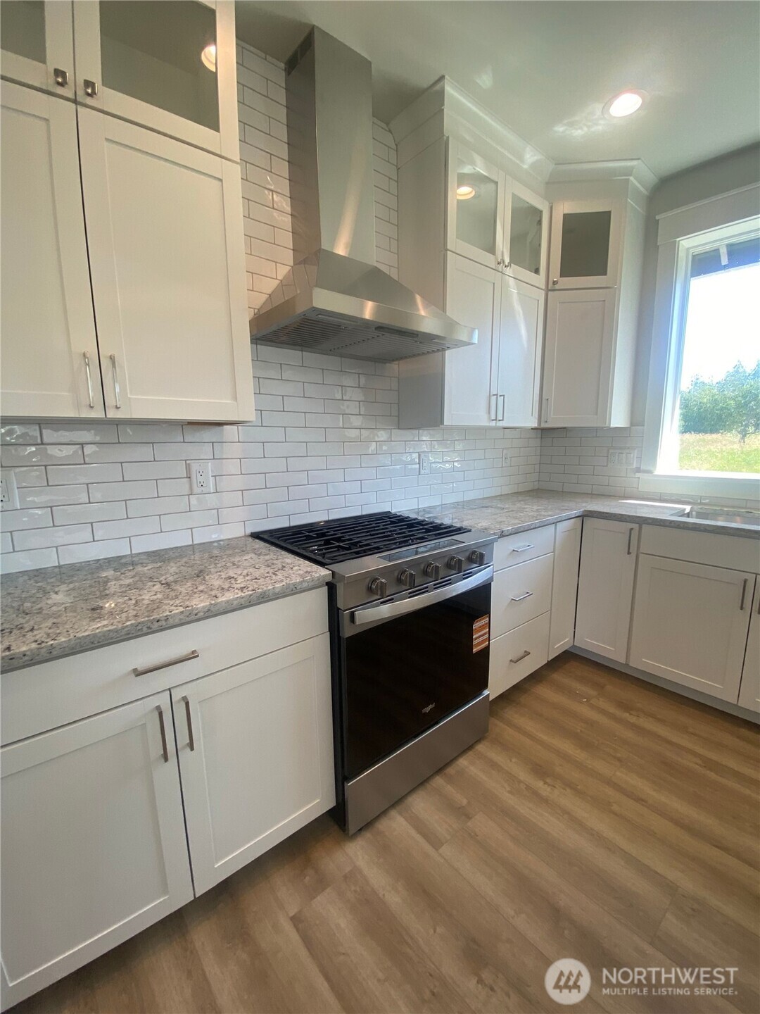 5953 (lot 64) Ranch Loop Ferndale, WA 98248 - Photo 8 of 38 a kitchen with granite countertop white cabinets and white appliances