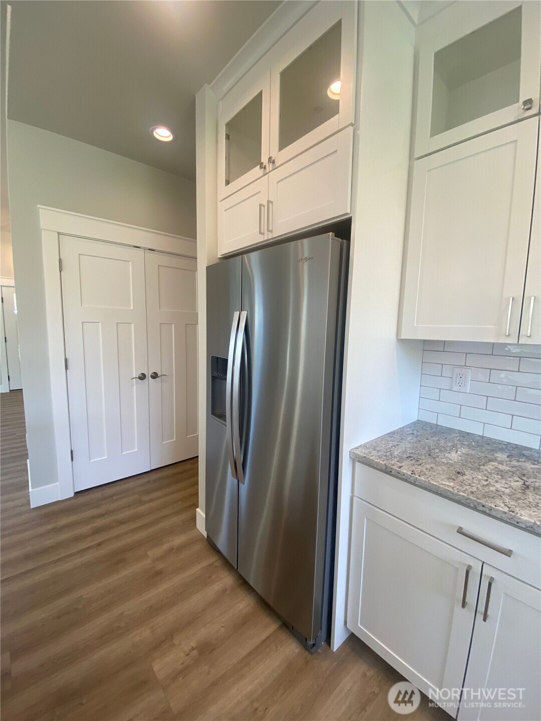 5953 (lot 64) Ranch Loop Ferndale, WA 98248 - Photo 9 of 38 a kitchen with granite countertop a refrigerator and cabinets