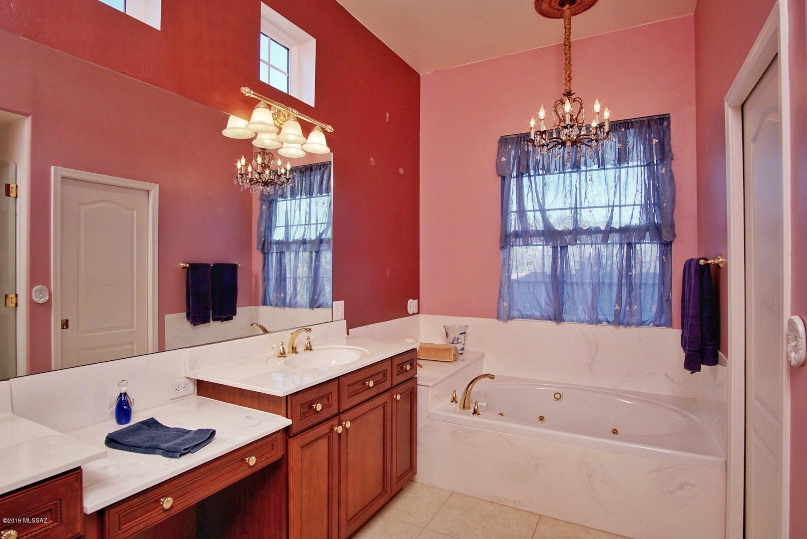 1137 Avenida Seville Rio Rico, AZ 85648 - Photo 10 of 19 a bathroom with a tub sink and mirror