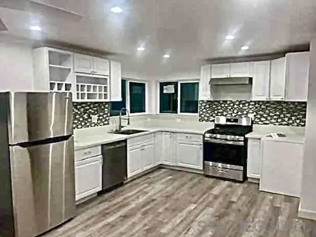 a kitchen with a refrigerator and a sink