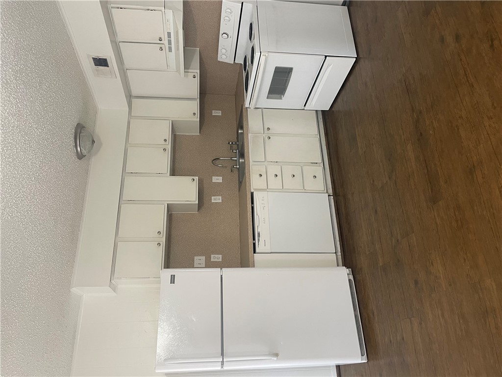 807 East 31st Street, Unit 8 Bryan, TX 77803 - Photo 4 of 7 a kitchen with stainless steel appliances granite countertop a stove a sink and white cabinets