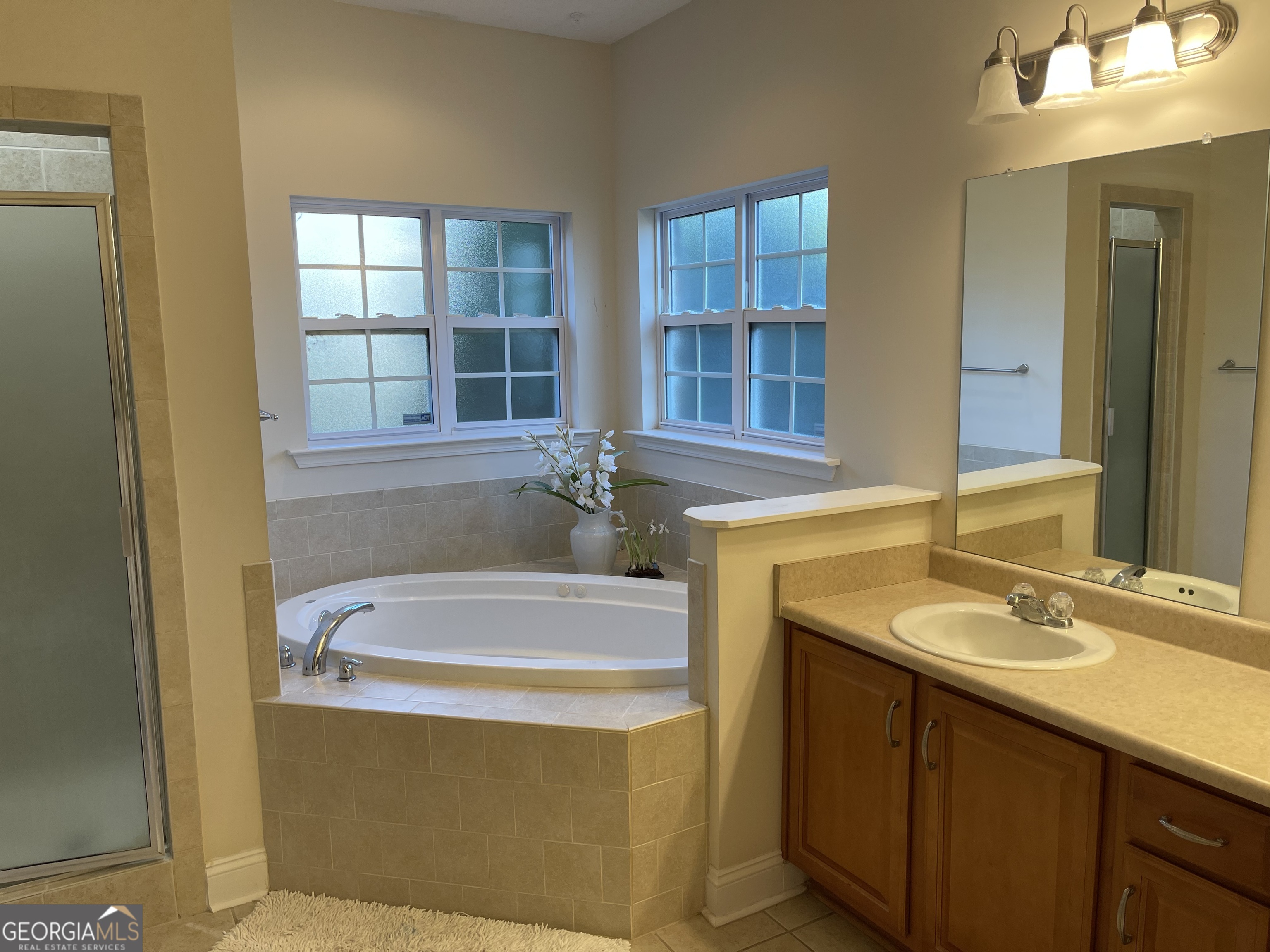 137 Blue Ridge Drive Statesboro, GA 30458 - Photo 16 of 26 a bathroom with a tub sink and mirror