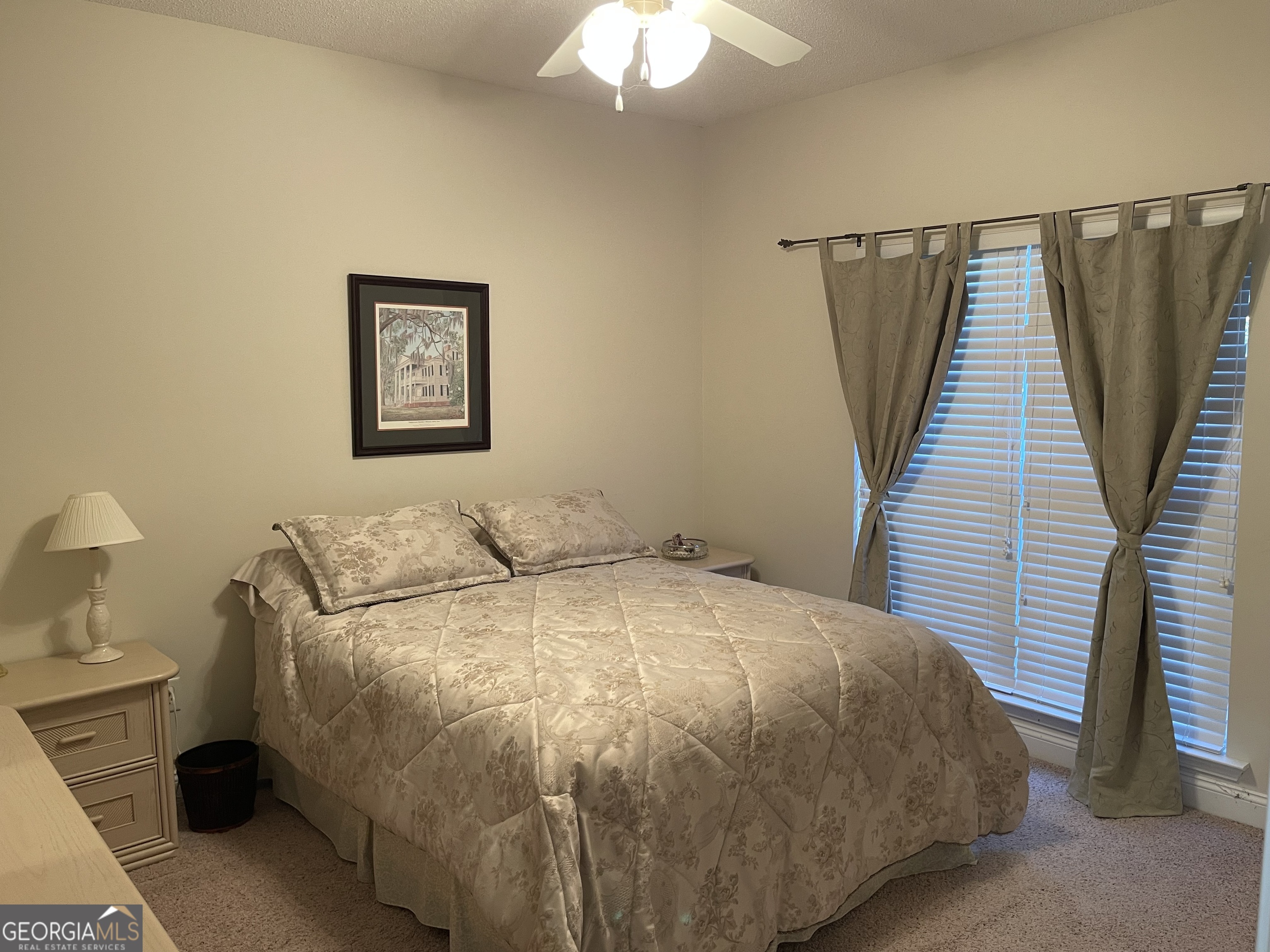 137 Blue Ridge Drive Statesboro, GA 30458 - Photo 18 of 26 a bedroom with a bed and a chandelier