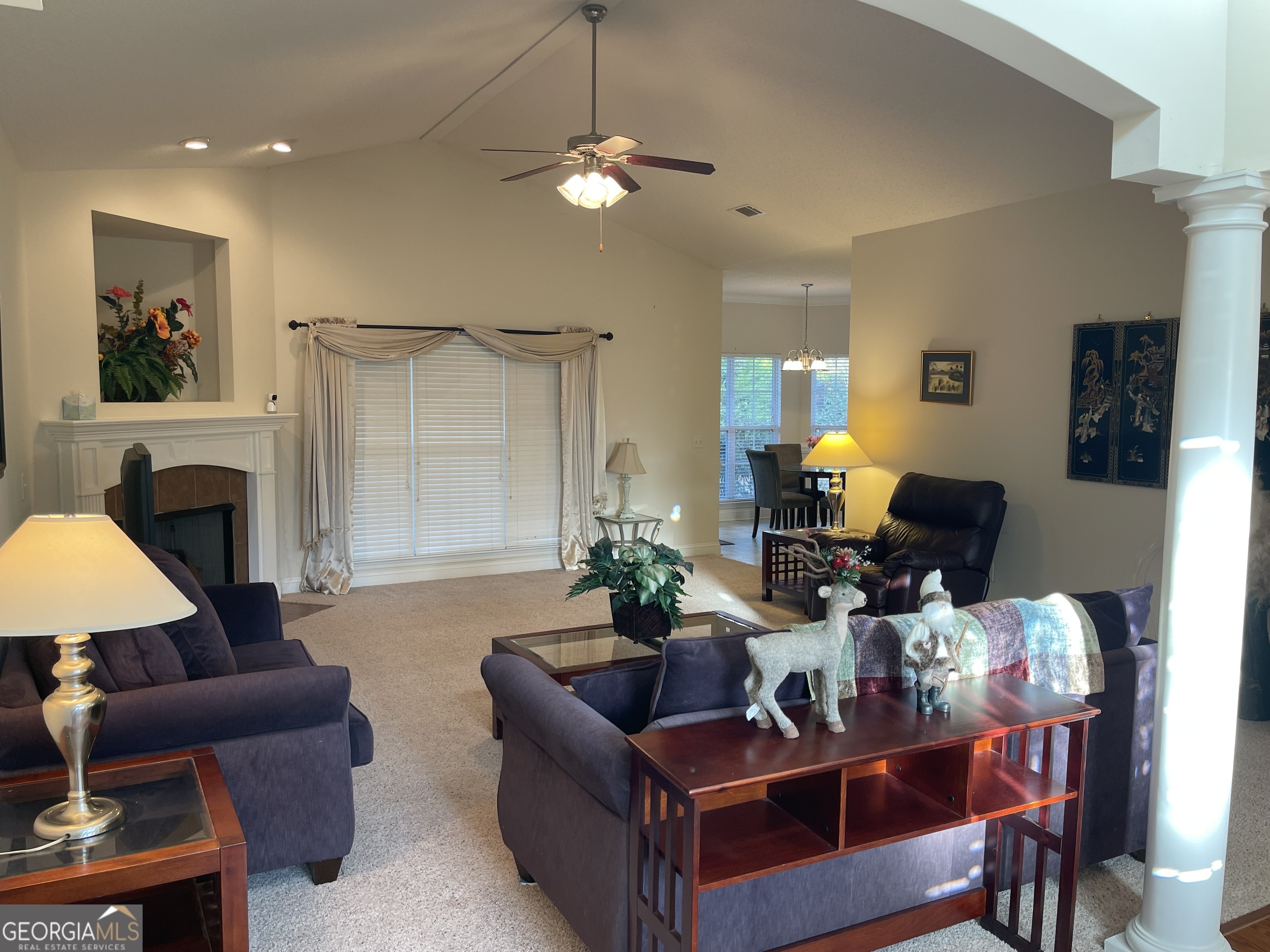 137 Blue Ridge Drive Statesboro, GA 30458 - Photo 4 of 26 a living room with furniture a fireplace and a chandelier