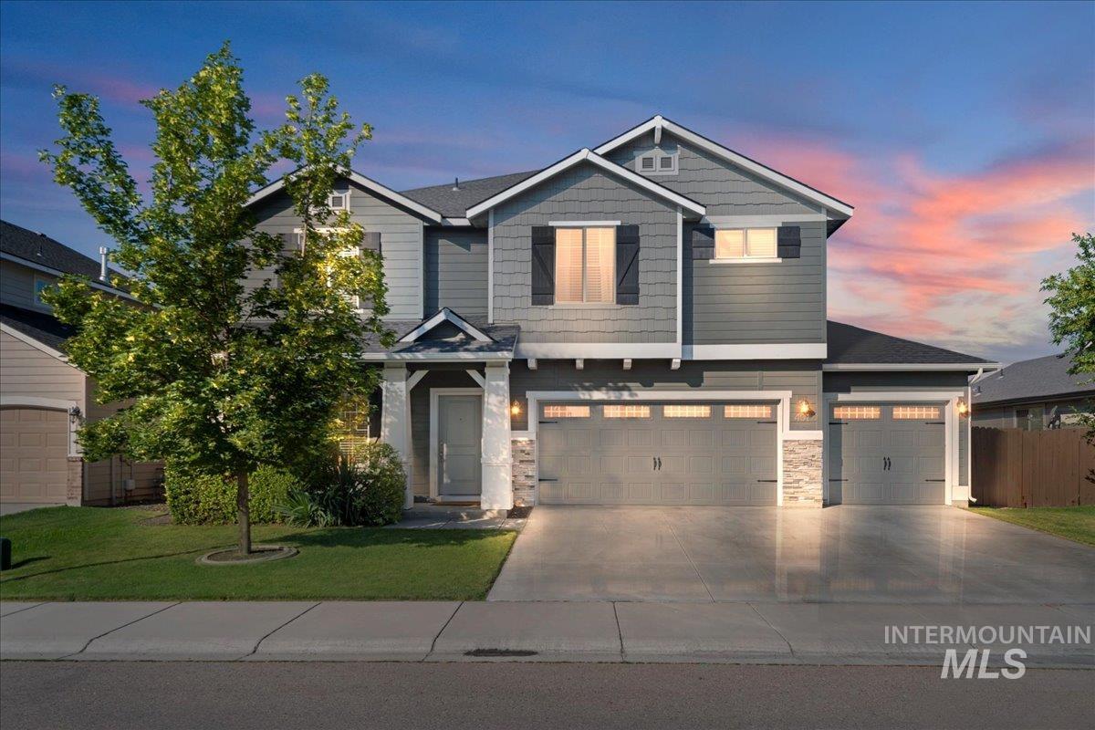 401 East Joshua Tree Drive Meridian, ID 83646 - Photo 1 of 32 Craftsman house featuring driveway, stone siding, and an attached garage