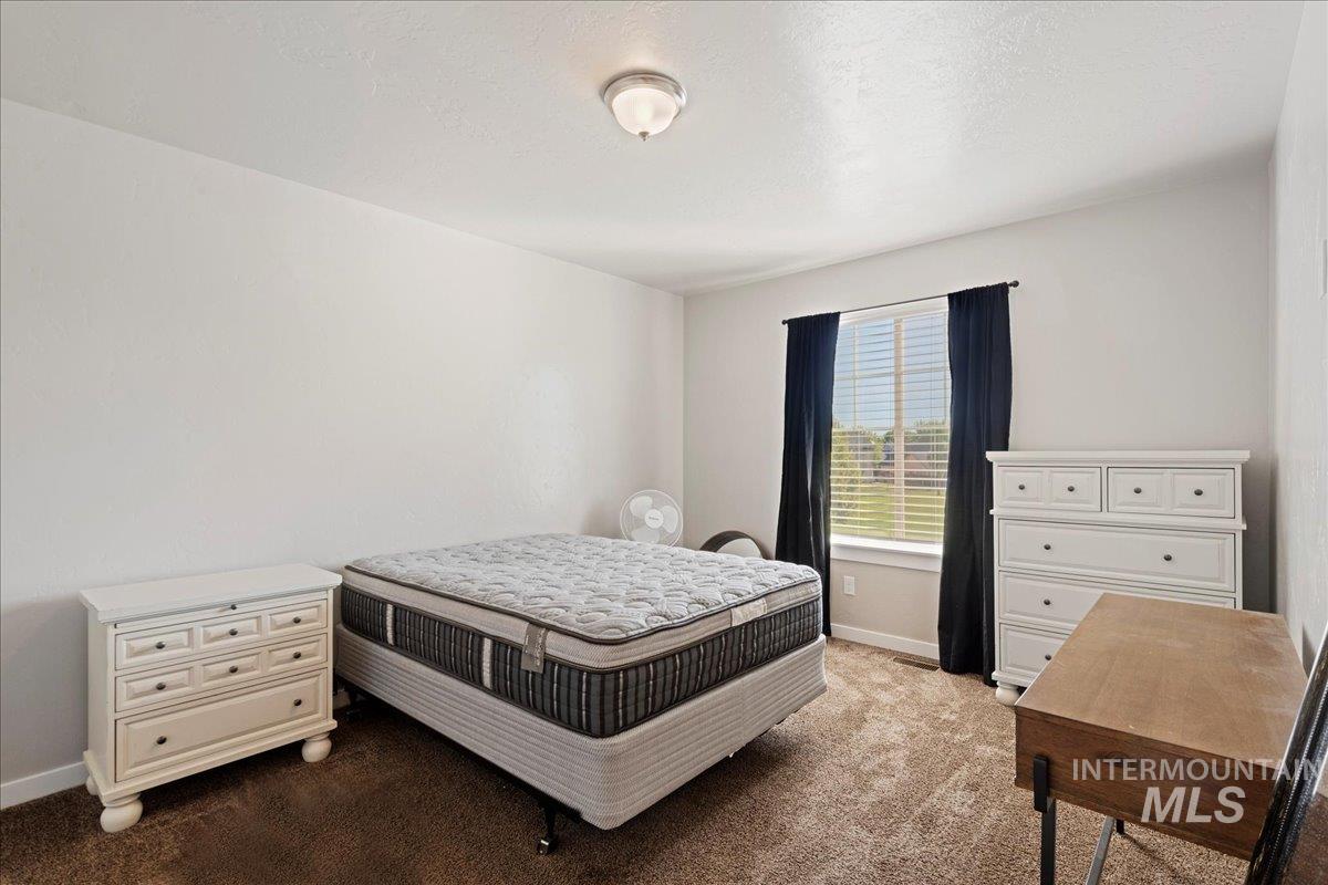 401 East Joshua Tree Drive Meridian, ID 83646 - Photo 15 of 32 Bedroom featuring carpet and baseboards