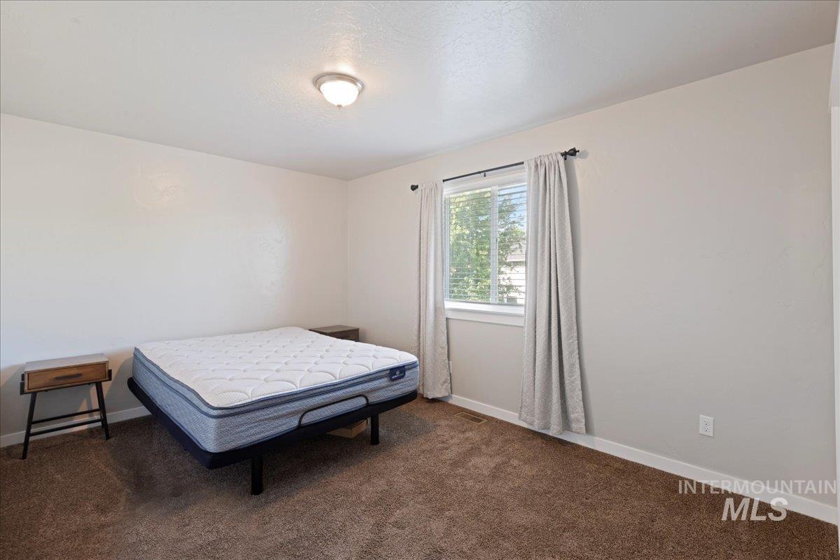 401 East Joshua Tree Drive Meridian, ID 83646 - Photo 16 of 32 Bedroom with carpet flooring and baseboards