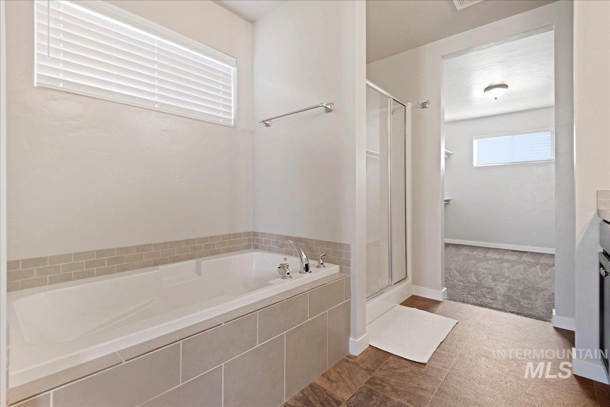 401 East Joshua Tree Drive Meridian, ID 83646 - Photo 18 of 32 Full bathroom with a bath, a shower stall, and vanity