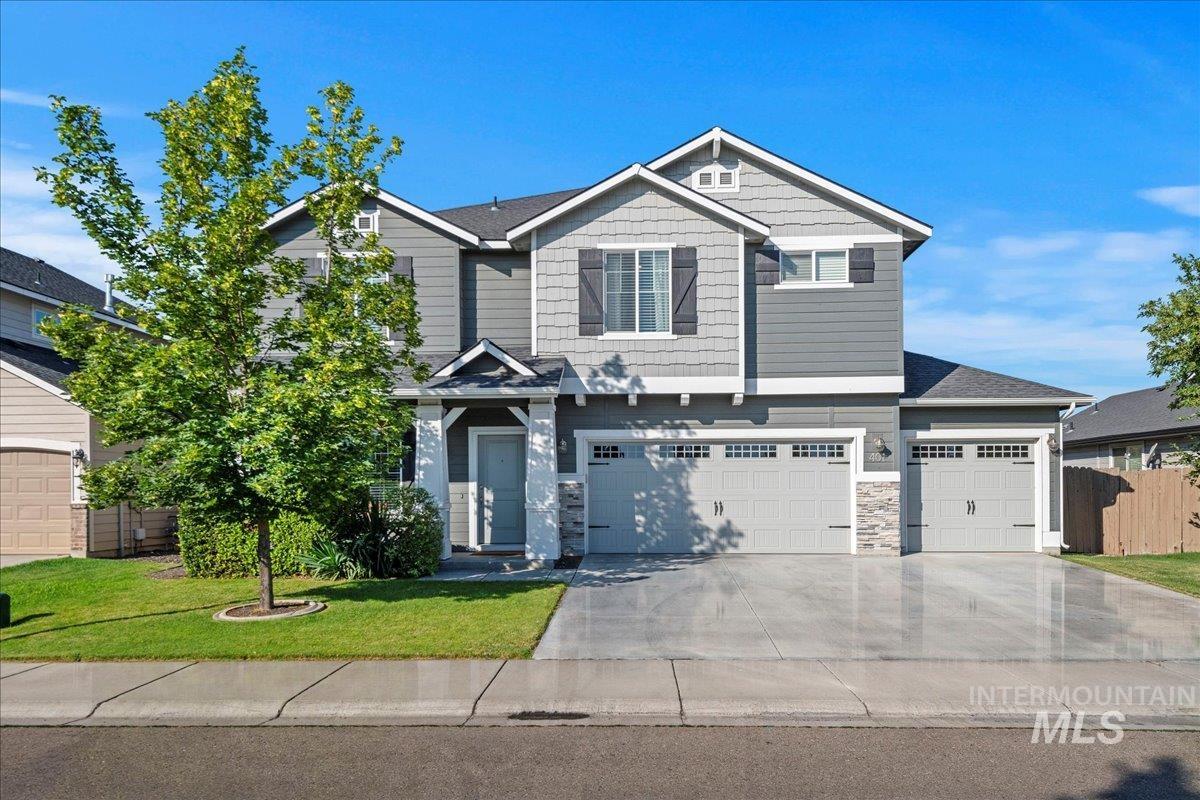 401 East Joshua Tree Drive Meridian, ID 83646 - Photo 2 of 32 Craftsman-style home featuring driveway, stone siding, and a garage
