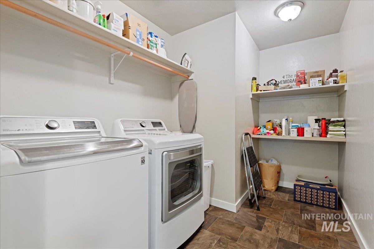 401 East Joshua Tree Drive Meridian, ID 83646 - Photo 24 of 32 Laundry area featuring washer and dryer and stone finish floors