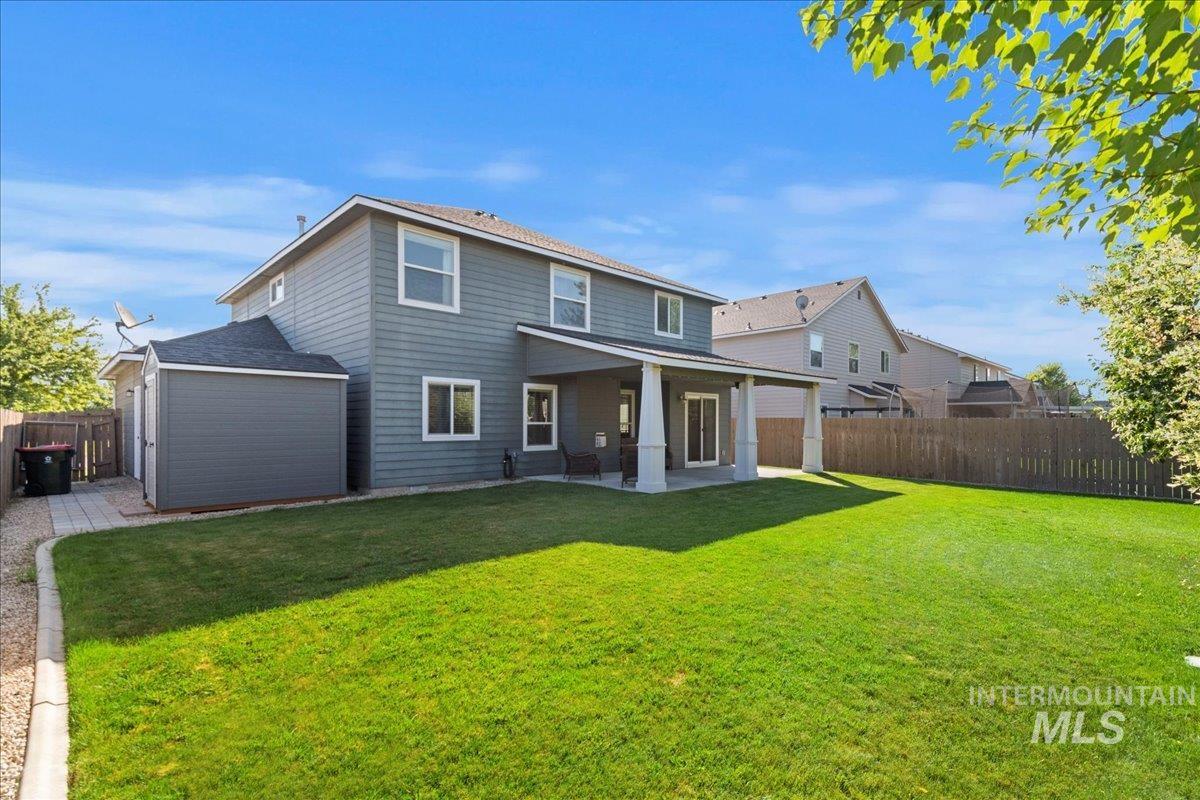 401 East Joshua Tree Drive Meridian, ID 83646 - Photo 29 of 32 Rear view of house featuring a patio area and a fenced backyard