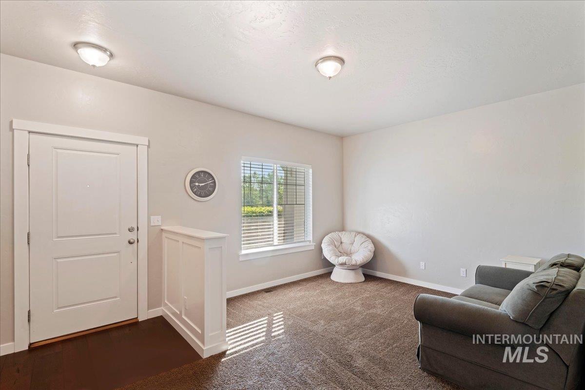 401 East Joshua Tree Drive Meridian, ID 83646 - Photo 5 of 32 Living area with baseboards and dark colored carpet