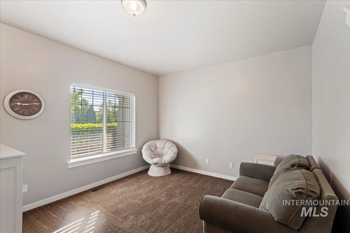 401 East Joshua Tree Drive Meridian, ID 83646 - Photo 6 of 32 Sitting room featuring baseboards and dark carpet
