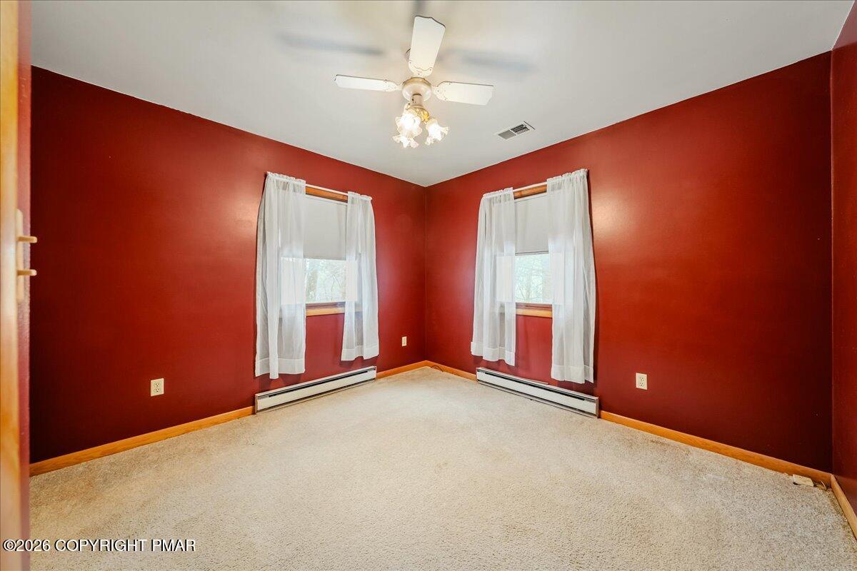 626 Northway Road Linden, PA 17744 - Photo 11 of 28 an empty room with windows and chandelier fan
