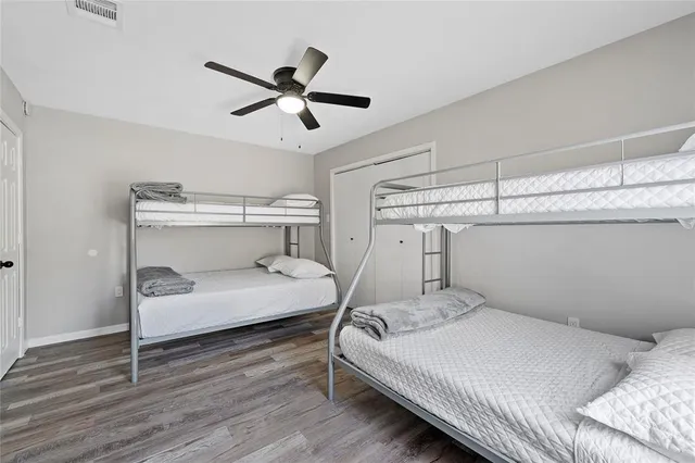 a bedroom with a bed and a ceiling fan