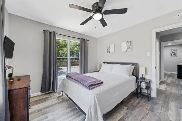 a bedroom with a bed and a flat tv screen on dresser