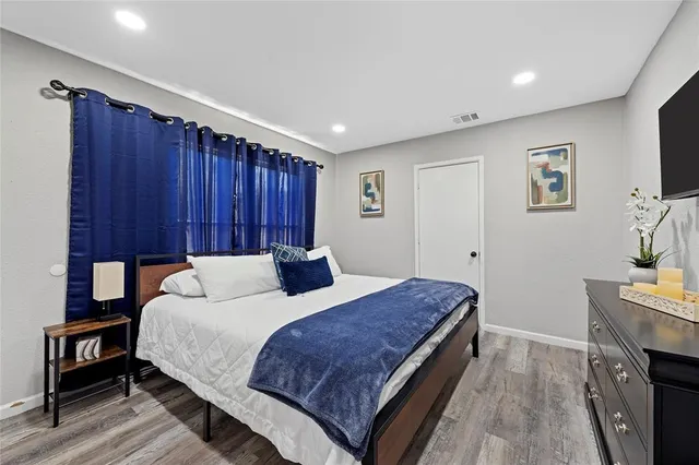 a bedroom with a bed and a flat screen tv