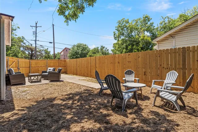 a backyard of a house with table and chairs