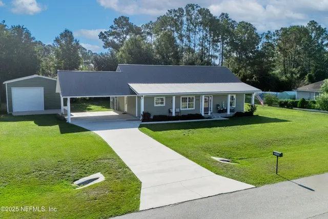 a view of house with garden space and trees