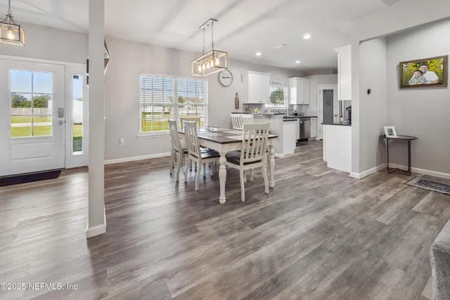 a kitchen with granite countertop a refrigerator stove and sink