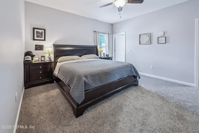a bathroom with a granite countertop sink a toilet and a mirror