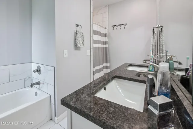a view of a hallway with wooden floor and a livingroom