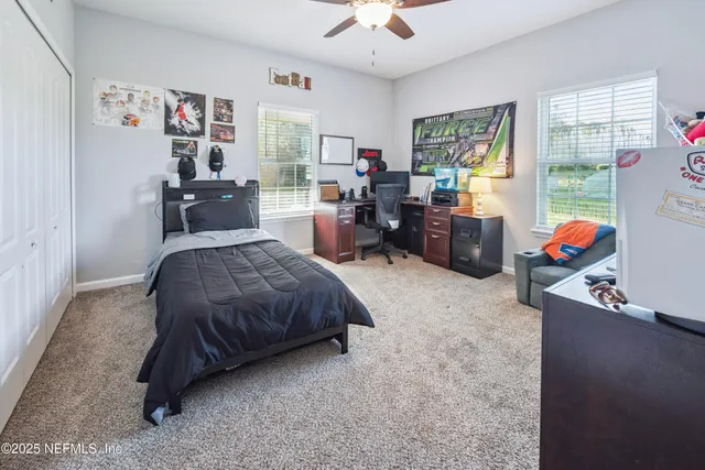 a bedroom with a bed and a mirror on dresser