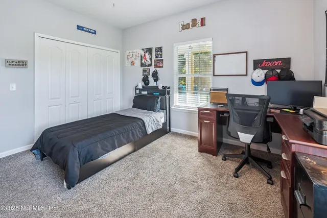 a bathroom with a granite countertop sink a toilet and a shower
