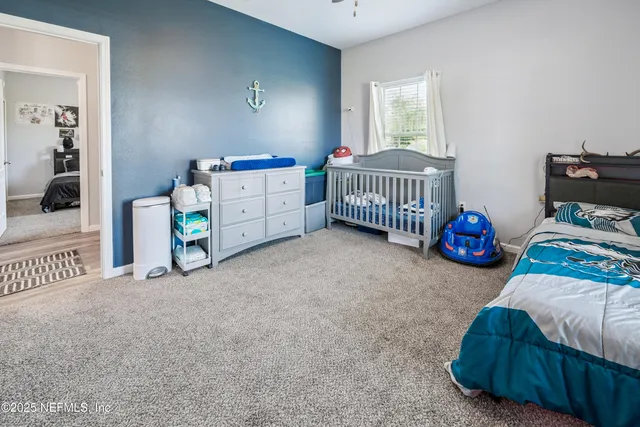 a bedroom with a bed and a dresser