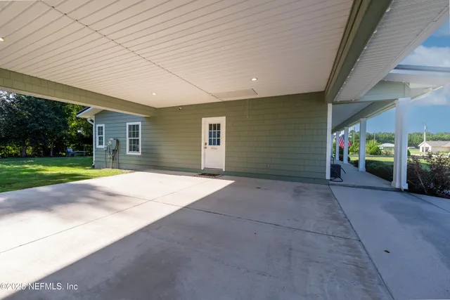 a view of a porch with chairs and backyard